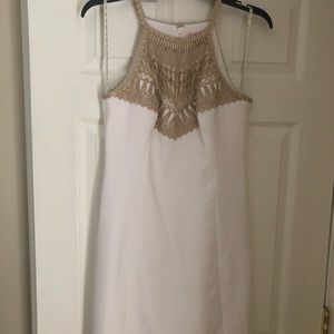 White Lilly Pulitzer dress with gold accents.